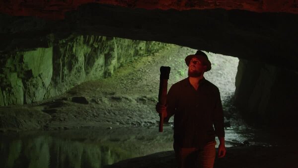 Man Exploring a Cave