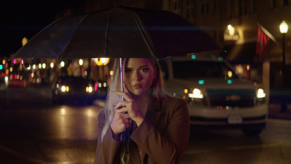 Girl Holding Umbrella at Night